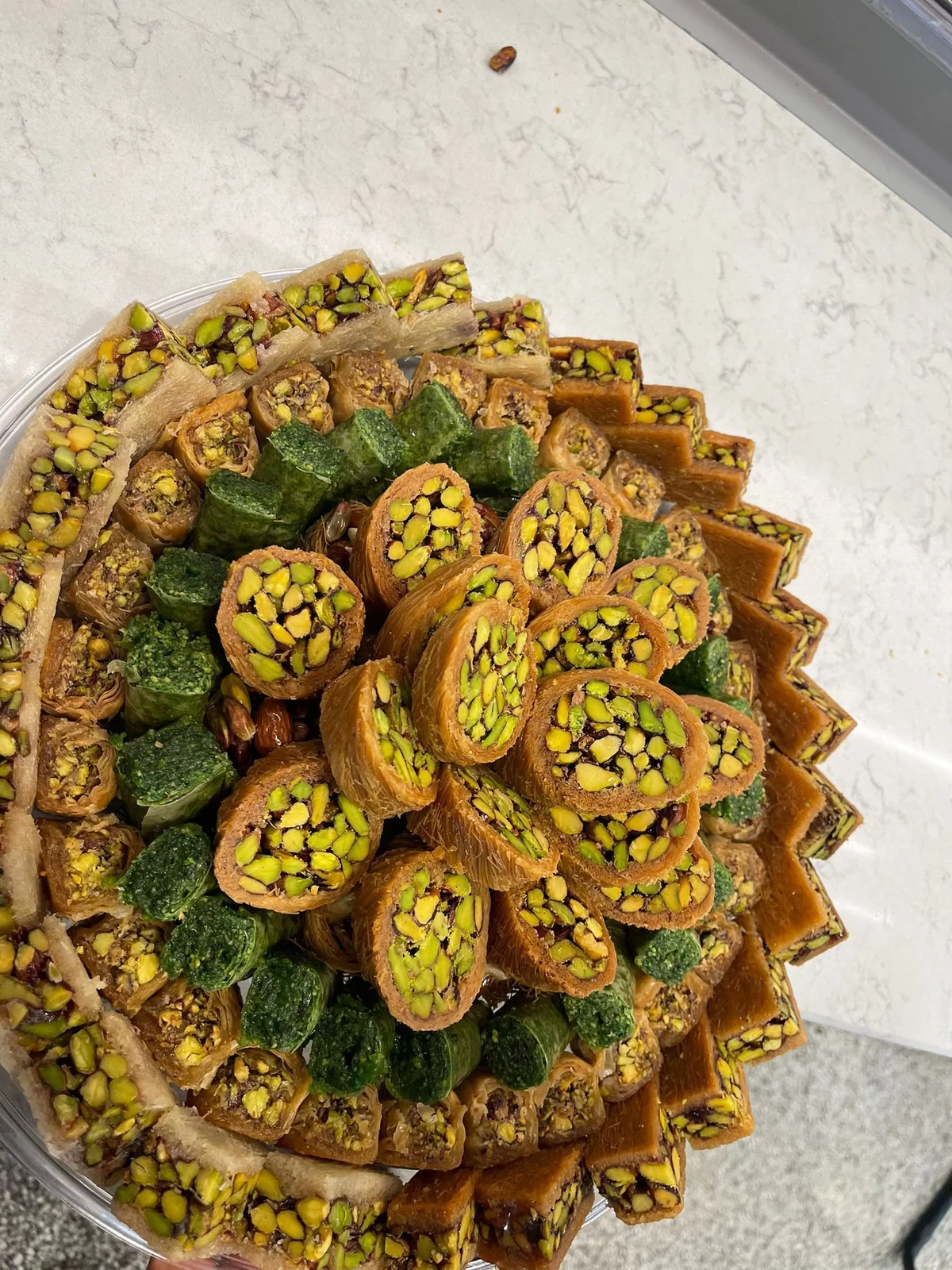 Display of assorted Syrian sweets with pistachio